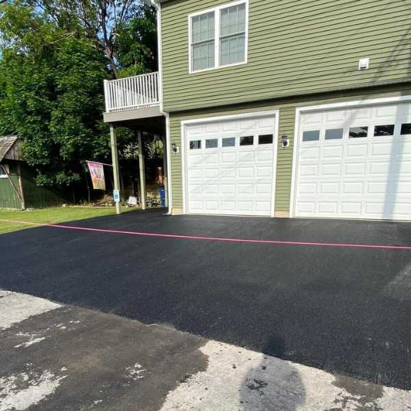 Image of a paved driveway infront of a double garage 